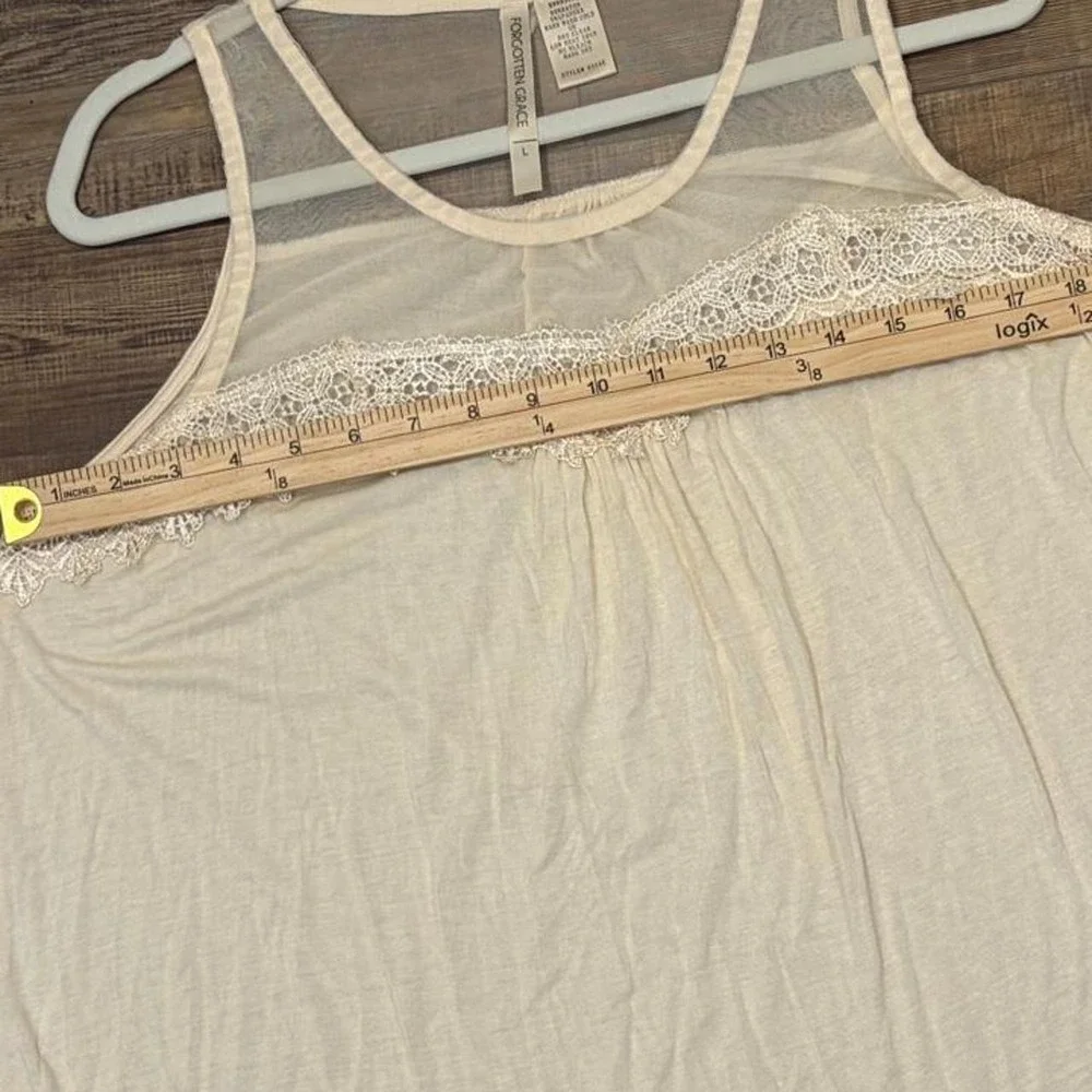 Cream lace tank top with sheer mesh and lace trim on the shoulders